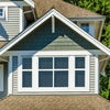 Close-up of a house gable with a multi-paned 10% VLT static cling tinted window and green shingled upper wall.